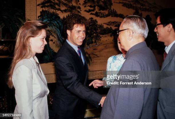 British royal Lady Sarah Armstrong-Jones watches as her brother, David Armstrong-Jones, 2nd Earl of Snowdon and Chinese President Li Xiannian shake...