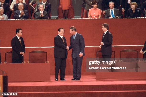 Chinese President Jiang Zemin and Britain royal Prince Charles shake hands during the official ceremony for the return of Hong Kong to Chinese rule,...