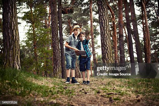 boys with digital tablet in forest - geocaching stock pictures, royalty-free photos & images