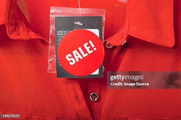 sale tag on red blouse - clothing tag stock pictures, royalty-free photos & images