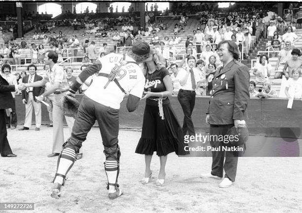Watched by American disc jockey Steve Dahl , Chicago White Sox catcher Mike Colbern kisses model Lorelei Shark during an anti-disco promotion at...