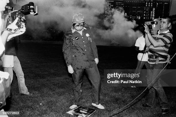 American disc jockey Steve Dahl stares at a pile of records on the field during an anti-disco promotion at Comiskey Park, Chicago, Illinois, July 12,...