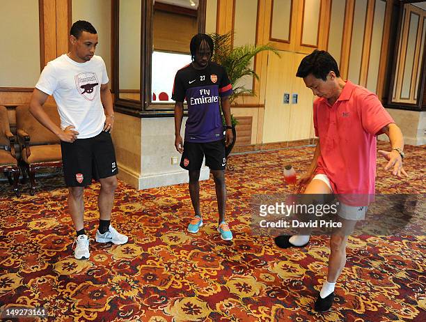 Gervinho and Francis Coquelin of Arsenal FC have a demonstration of Jianzi in the St. Regis Hotel in Beijing during their pre-season Asian Tour in...
