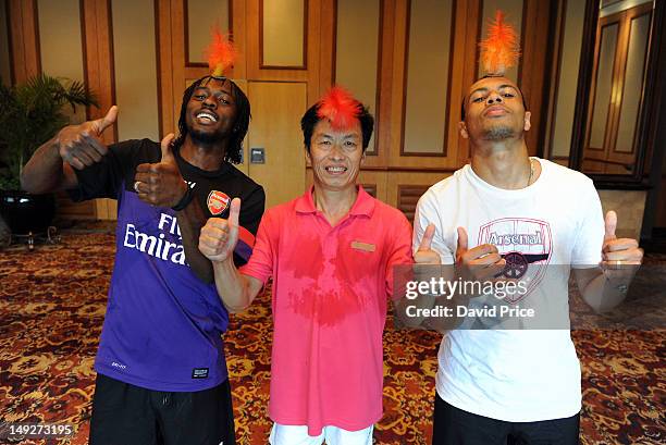 Gervinho and Francis Coquelin of Arsenal FC have a demonstration of Jianzi in the St. Regis Hotel in Beijing during their pre-season Asian Tour in...