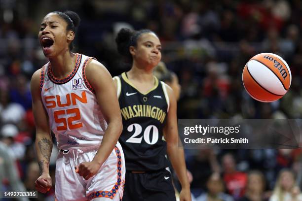 Tyasha Harris of the Connecticut Sun celebrates in front of Kristi Toliver of the Washington Mystics during the first half at Entertainment & Sports...