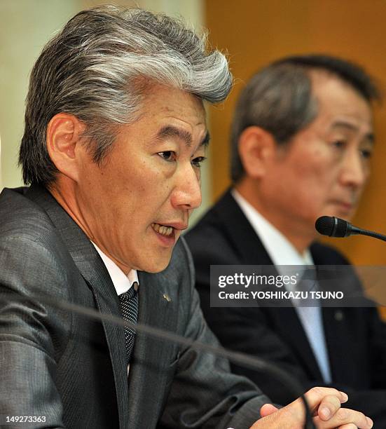 Newly appointed Chief Executive of Japan's securities firm Nomura Holdings Group Koji Nagai speaks before press as resigned Chief Executive Kenichi...