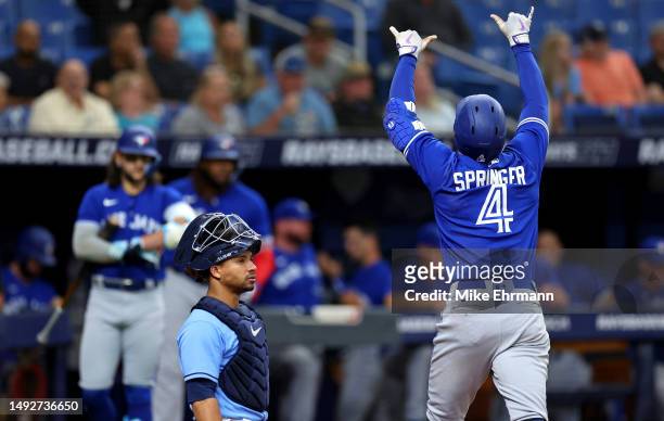George Springer of the Toronto Blue Jays reacts after hitting a home run in the third inning during a game against the Tampa Bay Rays at Tropicana...