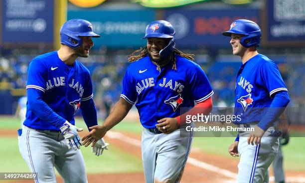 Vladimir Guerrero Jr. #27 of the Toronto Blue Jays reacts after hitting a grand slam home run in the ninth inning during a game against the Tampa Bay...