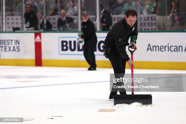 An ice-crew member cleans the ice after fans throw debris during the second period in Game Three of the Western Conference Final of the 2023 Stanley...