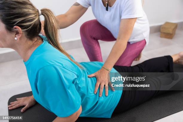 meditation and yoga class - human back stock pictures, royalty-free photos & images