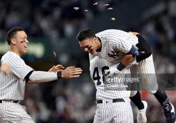 Aaron Judge,Anthony Rizzo and Anthony Volpe of the New York Yankees celebrate the win over the Baltimore Orioles after Volpe drove in the game...