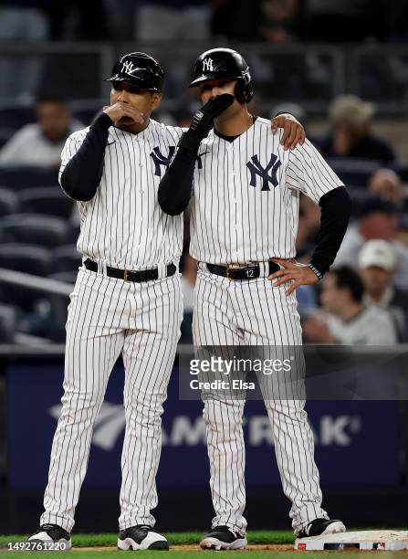 New York Yankees third base coach Luis Rojas talks with Isiah Kiner-Falefa as he stands on third base in the 10th inning against the Baltimore...