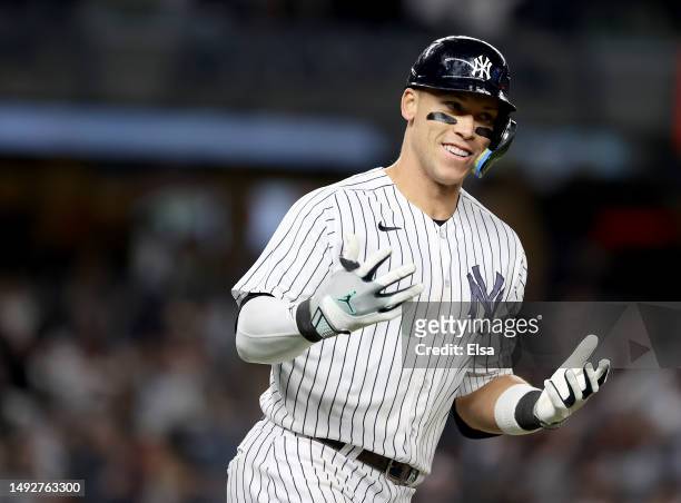 Aaron Judge of the New York Yankees celebrates his solo home run in the ninth inning to tie the game against the Baltimore Orioles at Yankee Stadium...