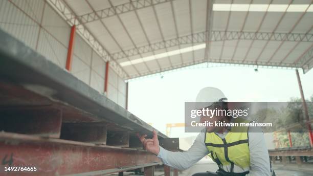engineer or contractor or foreman wearing safety uniform, inspect quality and quantity of blocks for making precast concrete in construction site of buildings or housing projects. employee or worker is working in real estate construction industry. - concrete block stock pictures, royalty-free photos & images
