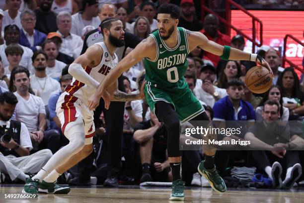 Jayson Tatum of the Boston Celtics drives against Caleb Martin of the Miami Heat during the fourth quarter in game four of the Eastern Conference...