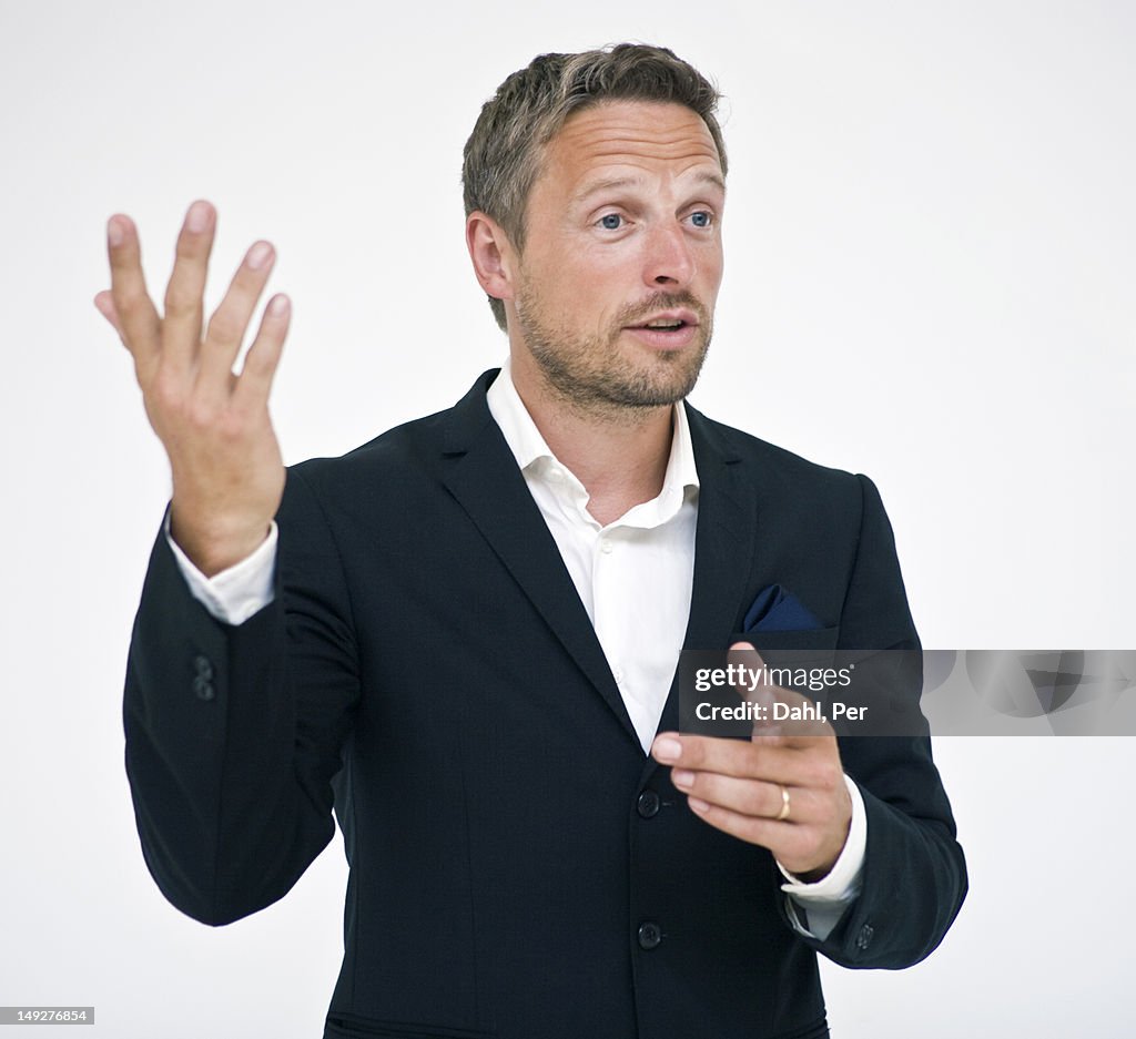 Studio portrait of businessman gesturing