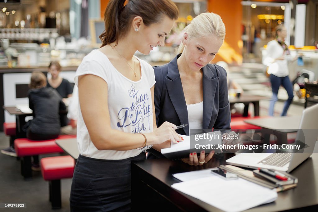 Two young women working with laptop