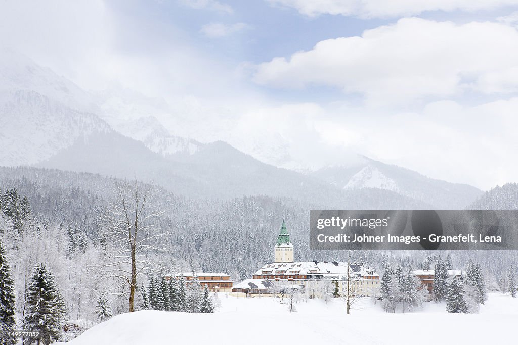 Scenic view of village surrounded by mountains