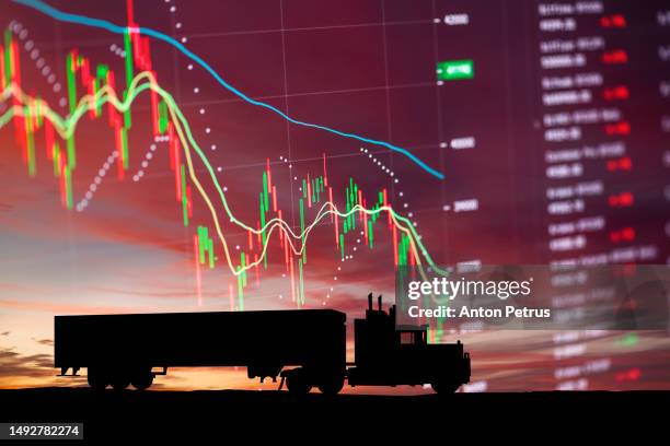 silhouette of a semi truck on economic data background - earnings season stock pictures, royalty-free photos & images