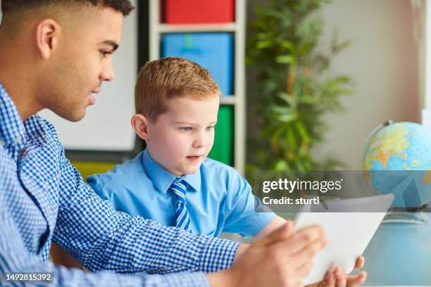 primary child with teacher - male teacher stock pictures, royalty-free photos & images