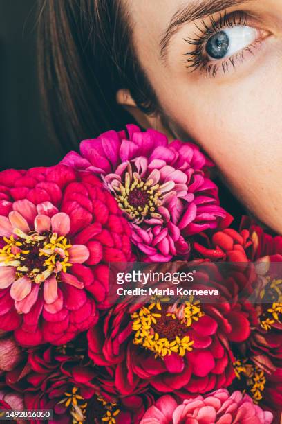 beautiful young woman smelling pink rose flower. the concept of perfume advertising. - vintage rose spray stockfoto's en -beelden