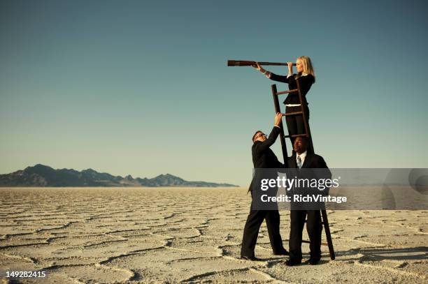 small business team search through telescope on salt flats - executive search bildbanksfoton och bilder