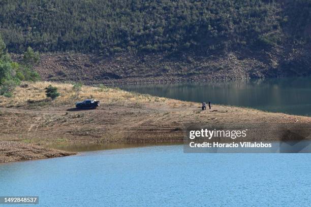 German and Portuguese Judiciary police members observe the search area near the waterline for remains of Madeleine McCann at Barragem do Arade...