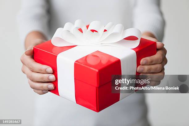 woman holding gift box, cropped - gift box tag stock-fotos und bilder