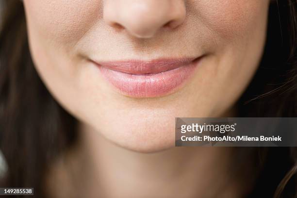 close-up of woman's smiling lips - woman mouth stock-fotos und bilder