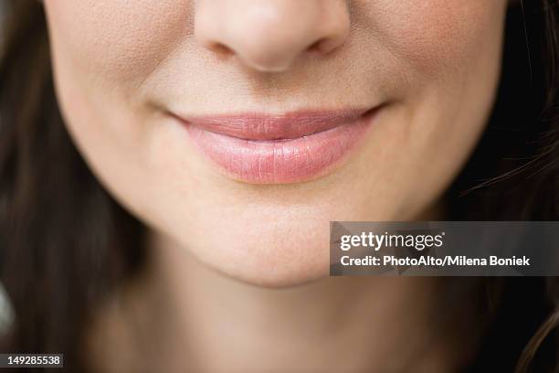 close-up of woman's smiling lips - boca fotografías e imágenes de stock