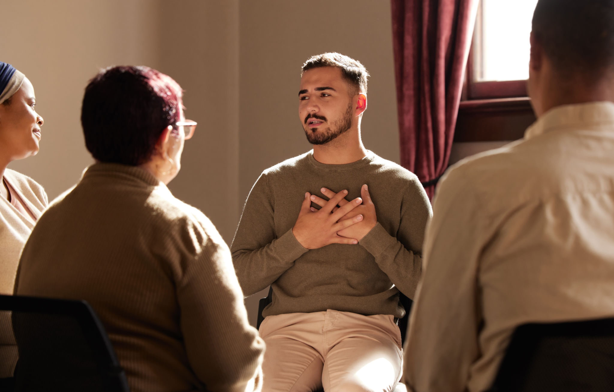Support, trust and man sharing in group therapy with understanding, feelings and talking in session. Mental health, addiction or depression, men and women with therapist sitting together for healing. Support, trust and man sharing in group therapy with understanding, feelings and talking in session. Mental health, addiction or depression, men and women with therapist sitting together for healing.