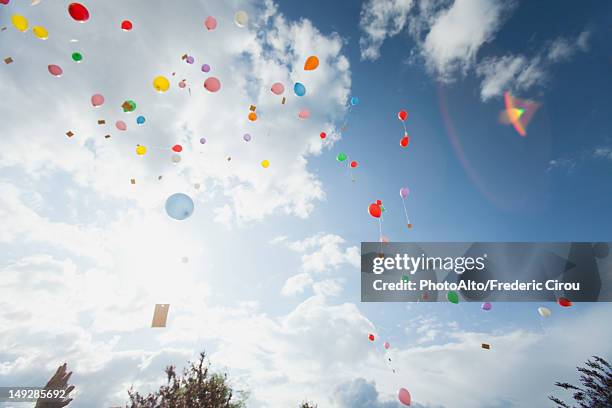 balloons floating toward sky - releasing balloons stock pictures, royalty-free photos & images