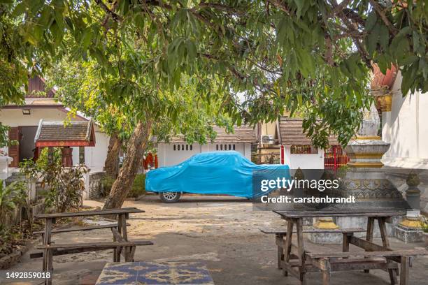 pick up truck under a tarpaulin - car cover in driveway stock pictures, royalty-free photos & images