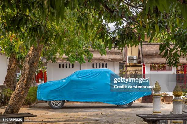 pick up truck under a tarpaulin - car cover in driveway stock pictures, royalty-free photos & images