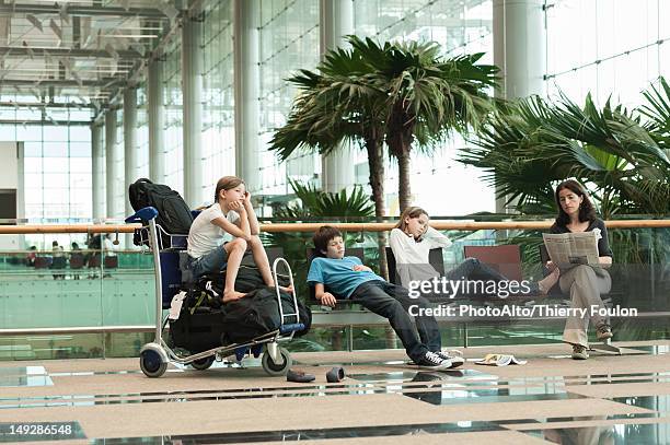 family waiting in airport terminal - waiting stock-fotos und bilder
