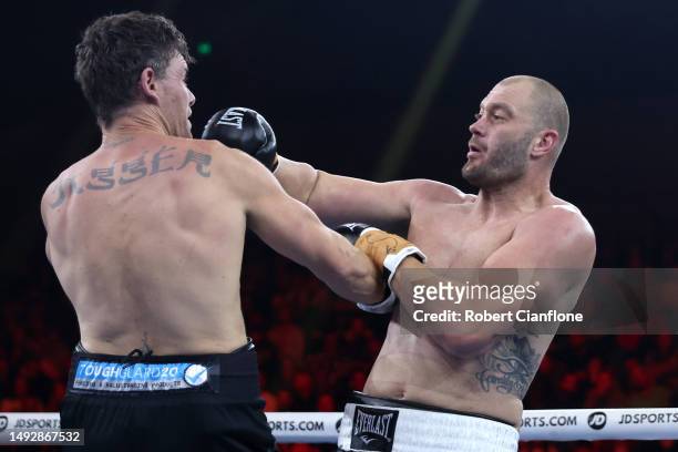 Tom Bellchambers exchanges punches with Cameron Mooney during their Heavyweight bout at Margaret Court Arena on May 24, 2023 in Melbourne, Australia.
