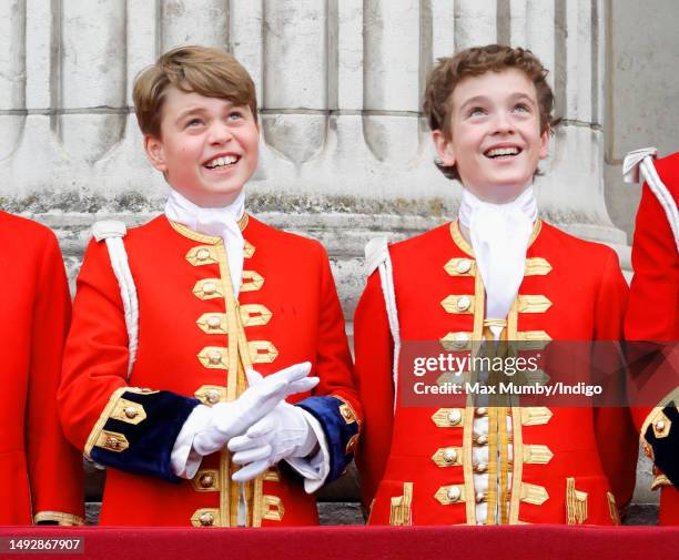 Prince George of Wales and Page of Honour Lord Oliver Cholmondeley watch an RAF flypast from the balcony of Buckingham Palace following the...