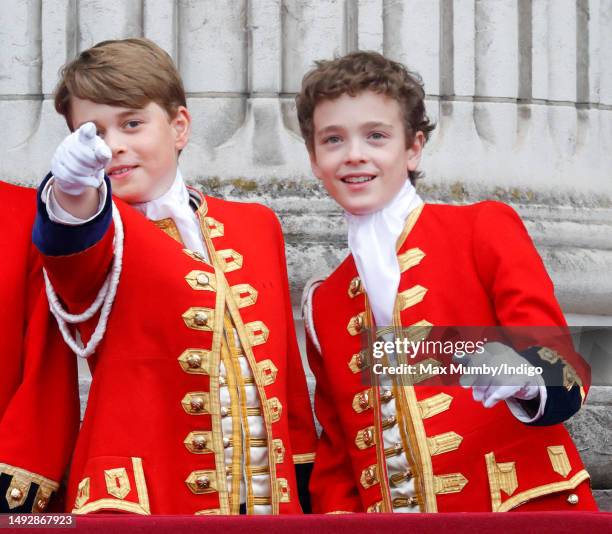 Prince George of Wales and Page of Honour Lord Oliver Cholmondeley watch an RAF flypast from the balcony of Buckingham Palace following the...