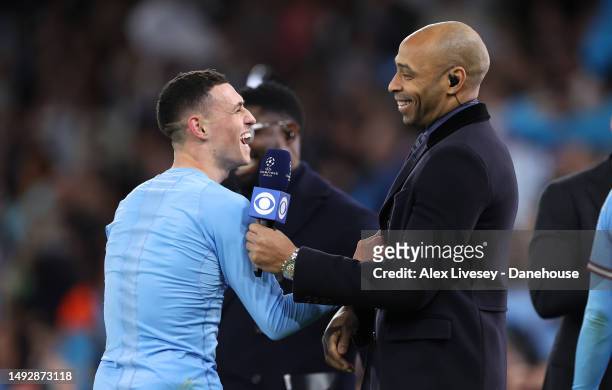 Phil Foden of Manchester City FC celebrates with football pundit Thierry Henry after the UEFA Champions League semi-final second leg match between...
