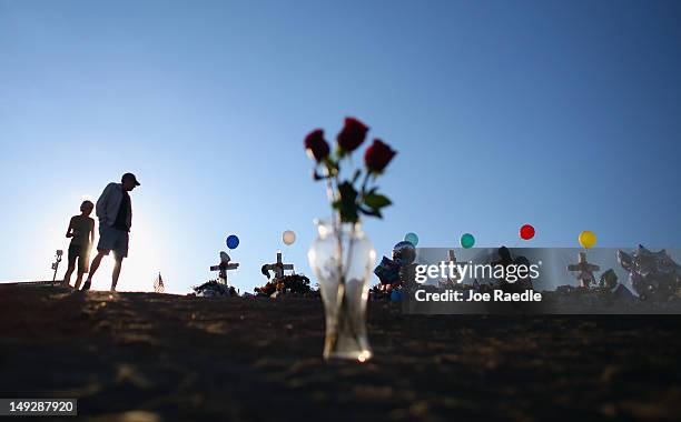 People visit a memorial setup across the street from the Century 16 movie theatre on July 26, 2012 in Aurora, Colorado. Twenty-four-year-old James...