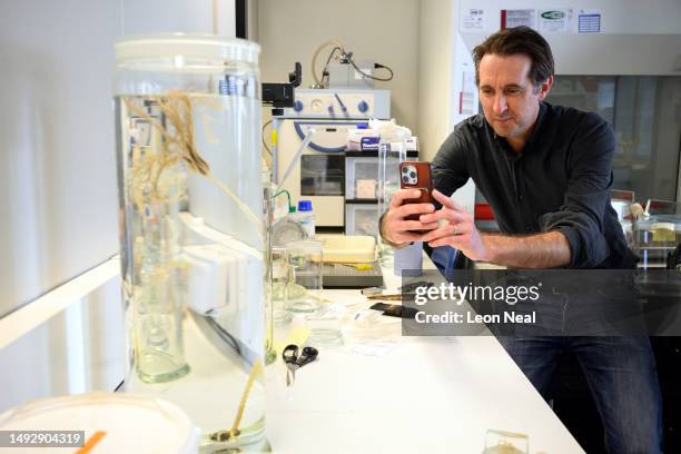 Merit Researcher Dr Adrian Glover takes a photo of a Crinoid, also known as a Sea Lily, after it was transferred into an ethanol-filled specimen jar...