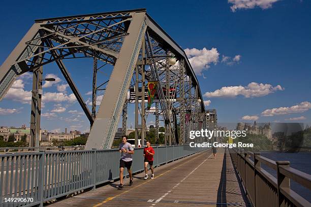 People jog across the river from Ottawa on the Alexandra Bridge on June 30, 2012 in Gatineau, Canada. Ottawa, the captial of Canada, is the fourth...