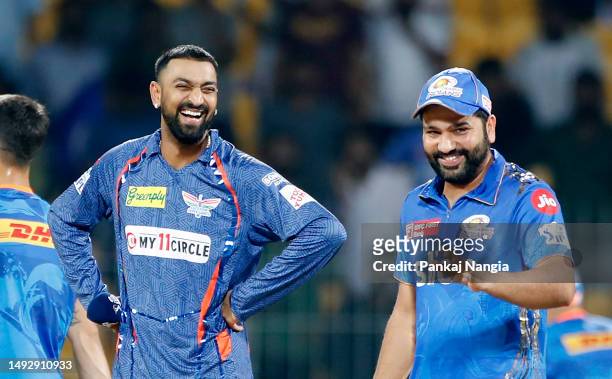 Krunal Pandya of Lucknow Super Giants speaks with Rohit Sharma of Mumbai Indians before the coin toss prior to the IPL Eliminator match between...