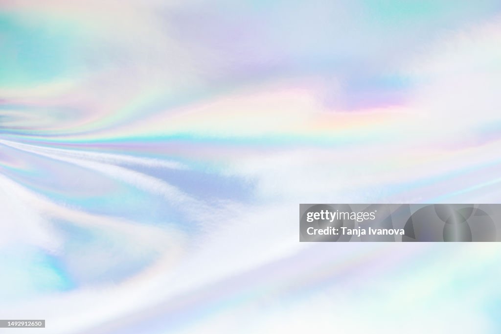Abstract Neon holographic background, with shimmering, iridescent effect with a rainbow of colors show the alternate reality of the metaverse. Meta and Web backgrounds and textures.