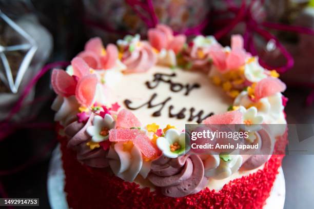 mother’s day cake close-up and background, sweets and sugar flowers for decoration, red sprinkles, selective focus - s stock pictures, royalty-free photos & images