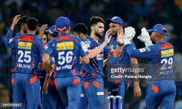 Naveen Ul Haq of Lucknow Super Giants celebrates with teammates after taking the wicket of Rohit Sharma of Mumbai Indians during the IPL Eliminator...
