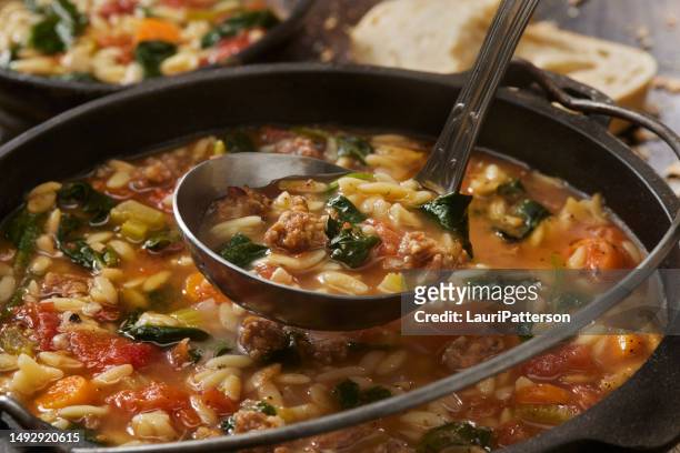 italian sausage and spinach orzo soup - risotto stock pictures, royalty-free photos & images