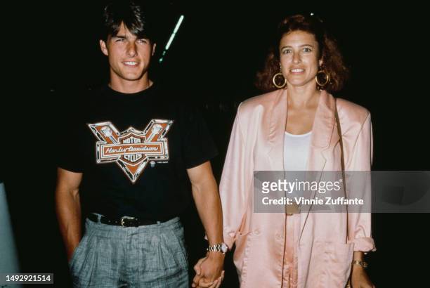 Tom Cruise and Mimi Rogers holding hands, United States, circa 1980s.
