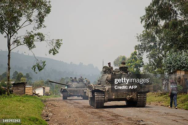 Congolese army tanks retreat through the village of Rugari, around 37km from Goma, following an alleged ambush by M23 rebels in the Democratic...