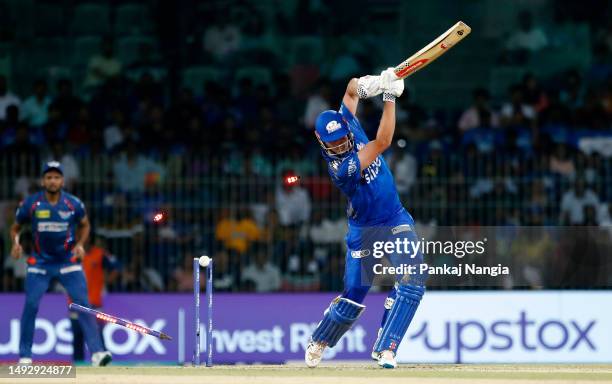 Cameron Green of Mumbai Indians is bowled is out by Naveen Ul Haq of Lucknow Super Giants during the IPL Eliminator match between Lucknow Super...